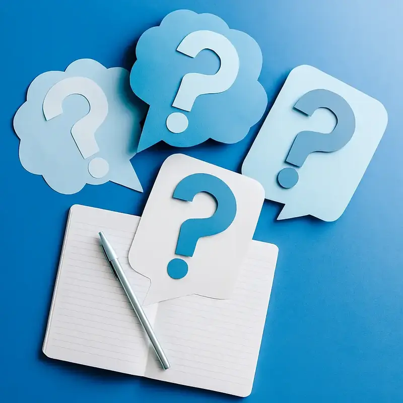 Notebook surrounded by paper question marks